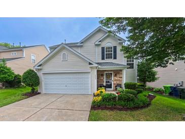 Charming home featuring well-manicured lawn, stone accents and a two-car garage at 5535 Spindlewood Ct, Durham, NC 27703