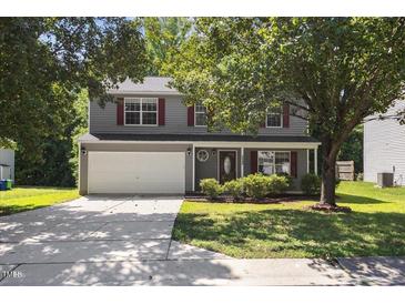 Charming two-story home featuring a gray exterior, red shutters, and a well-maintained front yard at 5940 Brambleton Ave, Raleigh, NC 27610