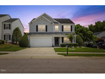 Charming two-story home with gray siding, white trim, attached garage, and a well-maintained front lawn at 8008 Bright Oak Trl, Raleigh, NC 27616