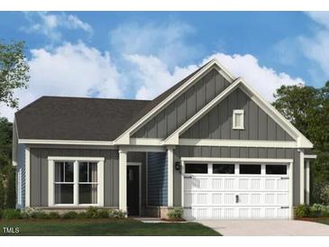 Charming gray home featuring a two-car garage, inviting front porch, and professionally landscaped front yard at 1105 Masters Place Way # 154, Durham, NC 27703