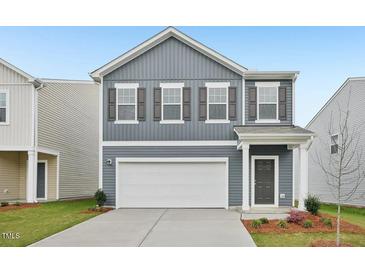 Charming two-story home with a two-car garage and well-maintained front lawn at 1168 Solace Way, Rolesville, NC 27571