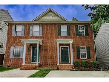 Brick two-story townhouse featuring classic architecture and well-maintained landscaping at 2459 Bay Harbor Dr, Raleigh, NC 27604