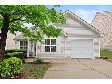 Charming single-story home featuring light siding, a one car garage, and a well-maintained front yard with manicured shrubs at 3108 Forrestal Dr, Durham, NC 27703