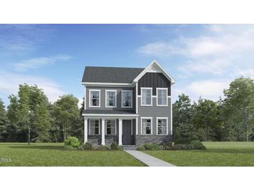 Charming two-story home with stone accents and a welcoming covered front porch at 312 Canyon Spring Trl, Wake Forest, NC 27587