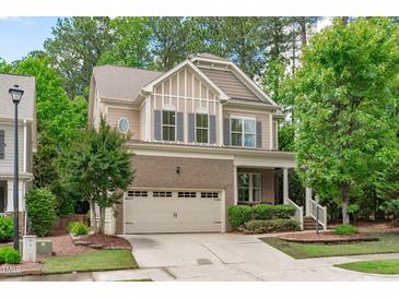 Charming two-story home with brick accents, a well-manicured lawn, and a two-car garage at 3304 Rockland Ridge Dr, Cary, NC 27519