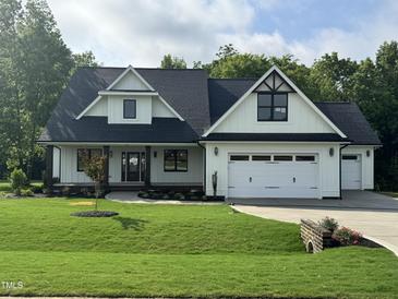 Charming two-story home with a well-manicured lawn and an attached two-car garage at 525 Allesandra Dr, Clayton, NC 27527