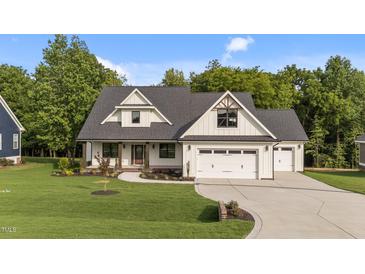 Charming home features a two-car garage, stone accents and a well-manicured lawn at 525 Allesandra Dr, Clayton, NC 27527