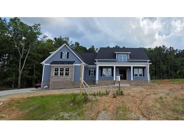 Inviting two-story home with a combination of blue siding and brick accents for a timeless exterior at 60 Stream View Way, Spring Hope, NC 27882
