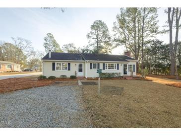 Charming single-story home featuring a gravel driveway, well-kept lawn, and classic curb appeal at 75 Hartwell Cir, Lillington, NC 27546