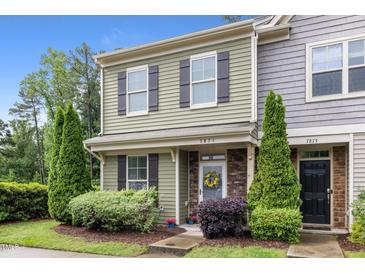 Charming two-story townhome featuring a well-manicured lawn and inviting entrance at 7871 Allscott Way, Raleigh, NC 27612