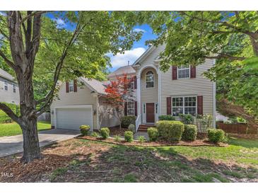Charming two-story home featuring a well-maintained lawn and a classic design with red shutters at 8504 Delavan Cir, Raleigh, NC 27613