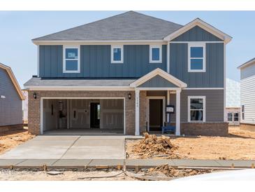 Two-story home featuring a two-car garage, brick accents, and modern architecture at 1108 Landen Creek Ln, Zebulon, NC 27597