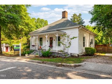 Charming home with white siding, inviting front porch, and well-manicured landscaping at 203 Brick St, Wake Forest, NC 27587