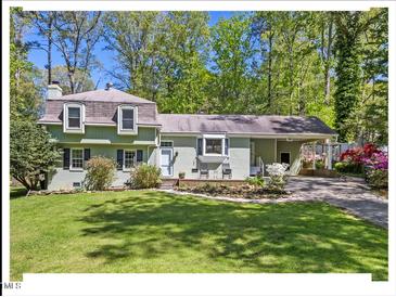 Charming home with a well-manicured lawn, established plantings and a convenient covered carport at 216 Brook Ln, Durham, NC 27712