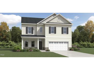 Charming two-story home with a covered front porch and a two-car garage in a residential area at 265 Sutherland Dr, Franklinton, NC 27525