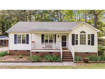 Charming single-story home with a cozy front porch and well-maintained landscaping in a quiet neighborhood at 300 Plantation Rd, Clayton, NC 27520