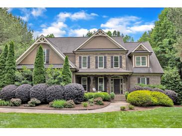 Beautiful two-story home with manicured landscaping, stone accents, and a welcoming front porch at 3007 Krogen Ct, Creedmoor, NC 27522