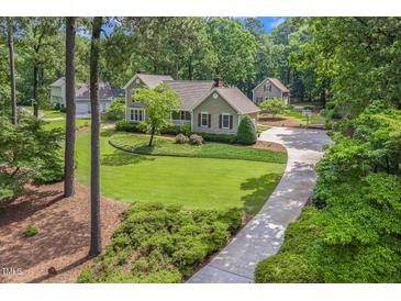 Charming two-story home with a well-manicured lawn, mature trees, and inviting curb appeal at 310 Cross Lake, Fuquay Varina, NC 27526