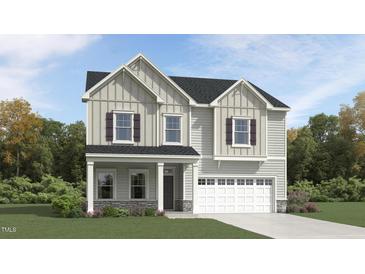 Charming two-story home featuring board and batten siding, a welcoming porch, and an attached two-car garage at 315 Sutherland Dr, Franklinton, NC 27525