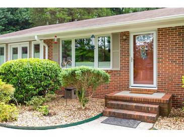 Charming brick home featuring a welcoming front door and landscaped garden at 3515 Luna Ln, Durham, NC 27705
