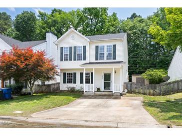 Charming two-story home featuring white siding, green shutters, and a well-manicured front lawn at 3634 Ranbir Dr, Durham, NC 27713