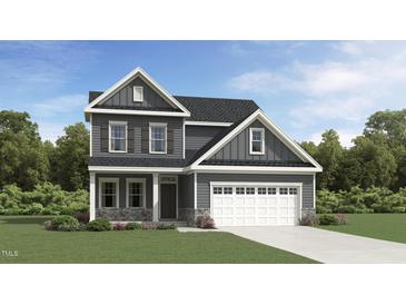 Beautiful new construction home with gray siding, stone accents, and an attached two-car garage at 75 Venture Ct, Franklinton, NC 27525