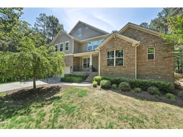 Charming two-story brick home with well-manicured landscaping and inviting curb appeal at 1009 Blue Larkspur Ave, Wake Forest, NC 27587