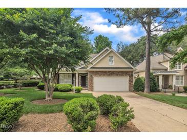 Charming home featuring a brick facade, well-manicured lawn, and an attached two-car garage at 1608 Heritage Links Dr, Wake Forest, NC 27587