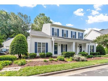 Charming two-story home with a welcoming front porch and beautifully landscaped front yard at 2010 Silky Dogwood Trl, Apex, NC 27502
