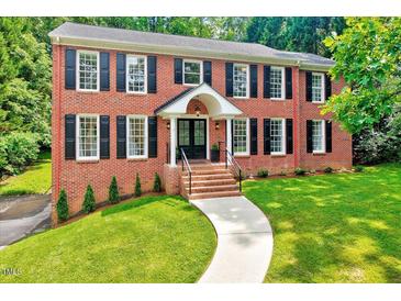 Charming brick two-story home featuring a manicured front yard and a welcoming entrance at 2109 W Marilyn Cir, Cary, NC 27513