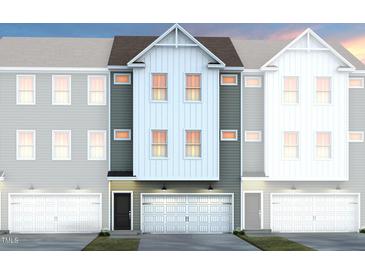 Charming townhome facade with a clean modern design and attached garage, showcasing a welcoming curb appeal at 2135 Grouse Ski Cir, Apex, NC 27523