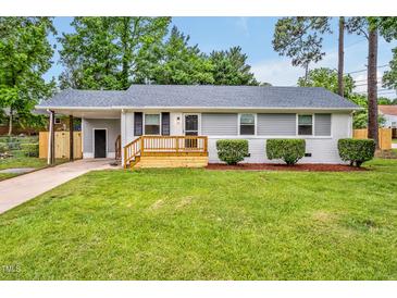Charming one-story home with gray siding, a freshly painted white brick facade, and a new wood deck at 2200 Wyman Pl, Durham, NC 27707