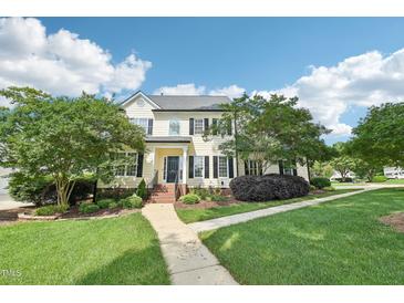 Charming two-story home featuring a well-manicured lawn, mature trees, and inviting walkway at 231 Heather Bluffs Dr, Garner, NC 27529