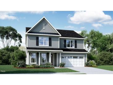 Charming two-story home with a two-car garage, manicured lawn, and lovely landscaping at 2964 Hanging Valley Way, Wake Forest, NC 27587