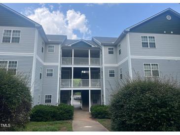 Attractive three-story condo building with balconies and professional landscaping at 3000 Centennial Woods Dr # 302, Raleigh, NC 27603