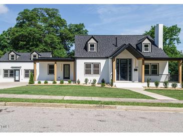 Stunning two-story home featuring a manicured lawn and modern black-and-white design elements at 316 Barbour St, Clayton, NC 27520