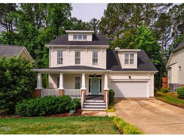 Charming two-story home with a welcoming front porch and manicured lawn, showcasing its curb appeal at 507 Vatersay Dr, Apex, NC 27502