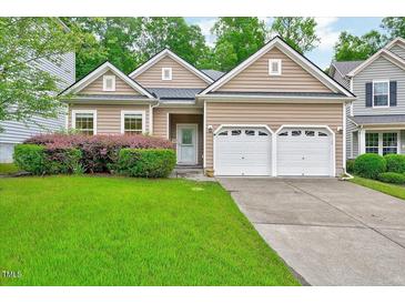 Charming home featuring a well-manicured lawn, tidy shrubbery and a two car garage at 921 Shefford Town Dr, Rolesville, NC 27571