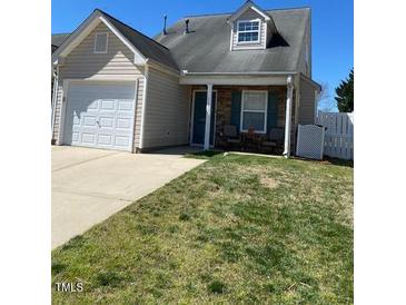 Charming home featuring a front yard, a garage, and a cozy front porch area at 11017 Peacock Moss St, Raleigh, NC 27613