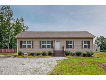 Inviting single-story home features a charming entrance and well-maintained landscaping at 153 Bywood Dr, Roxboro, NC 27573