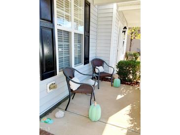 Cozy front porch area with seating and charming decorations, perfect for relaxing outdoors at 1633 Snow Mass Way, Durham, NC 27713