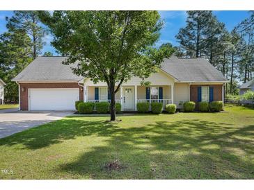 Charming single-story home featuring a brick and vinyl exterior, well-manicured lawn, and attached two-car garage at 169 Clearwater Harbor Hbr, Sanford, NC 27332