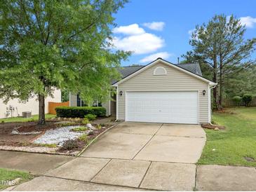 Charming home with a two-car garage, inviting curb appeal, and beautiful landscaping at 1728 E Honey Springs Ave, Fuquay Varina, NC 27526