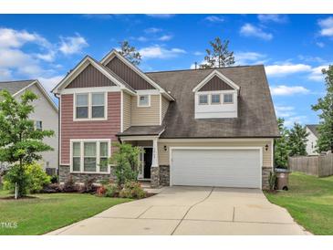 Charming two-story home featuring a spacious driveway and attached garage at 3413 Fairstone Rd, Wake Forest, NC 27587