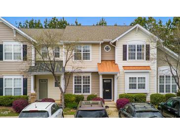 Charming townhome featuring neutral siding, black front door, and manicured landscaping at 4114 Brenmar Ln, Durham, NC 27713