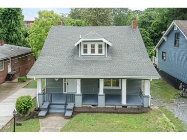 Charming home with a covered front porch, mature trees, and classic architectural details at 612 Dunbar St, Durham, NC 27701