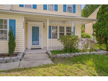 Charming home featuring a covered front porch and blue shutters at 7024 Beaverwood Dr, Raleigh, NC 27616