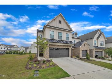 Charming two-story home with brick and siding, showcasing a well-manicured lawn and inviting curb appeal at 81 Paperwhite Pl # 213, Clayton, NC 27527