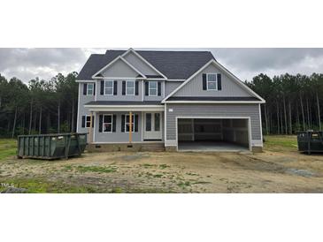 Two-story home featuring a spacious garage and classic gray siding at 98 Sanders Farm Drive, Smithfield, NC 27577