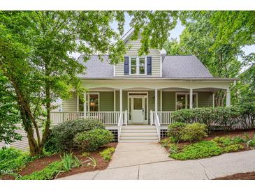 Charming two-story home with a welcoming front porch and landscaped yard, perfect for outdoor relaxation and curb appeal at 102 Newell St, Chapel Hill, NC 27516